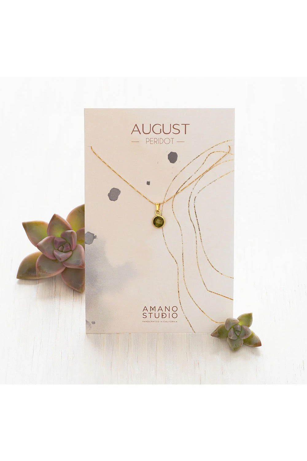 Birthstone necklace by Amano Studio, featuring a faceted gemstone on an 18-inch gold plated brass chain, displayed with crystals and description card.