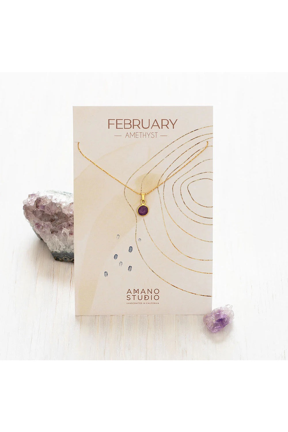 Birthstone necklace by Amano Studio, featuring a faceted gemstone on an 18-inch gold plated brass chain, displayed with crystals and description card.
