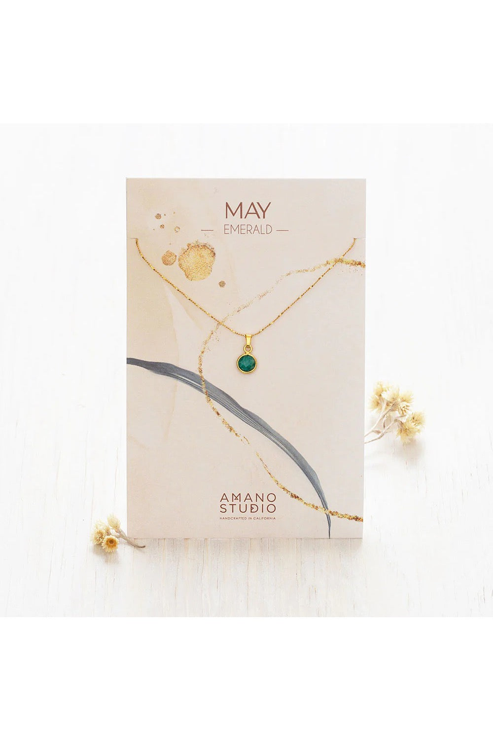Birthstone necklace by Amano Studio, featuring a faceted gemstone on an 18-inch gold plated brass chain, displayed with crystals and description card.