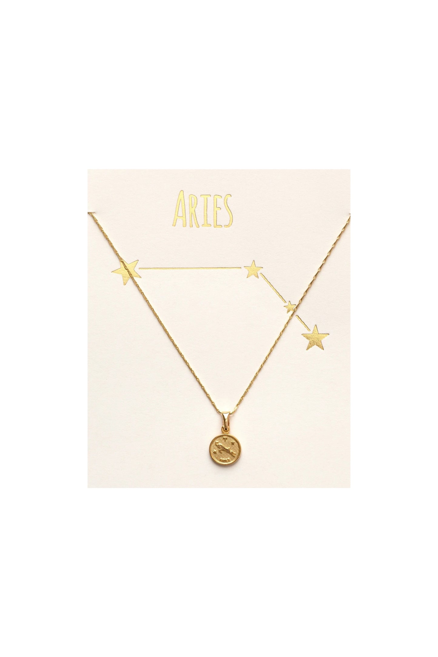 A gold-colored Tiny Zodiac Medallion Necklace displayed on a beige card with the word 'ARIES' written on it, featuring a small gold-plated brass medallion with a star motif, attached to a chain.